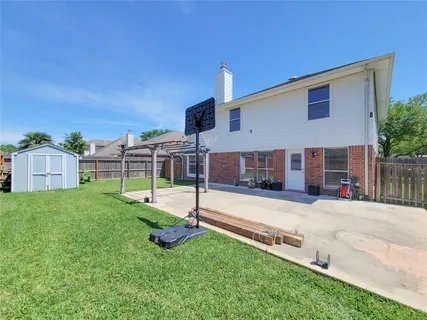 a view of a house with a backyard and a small yard