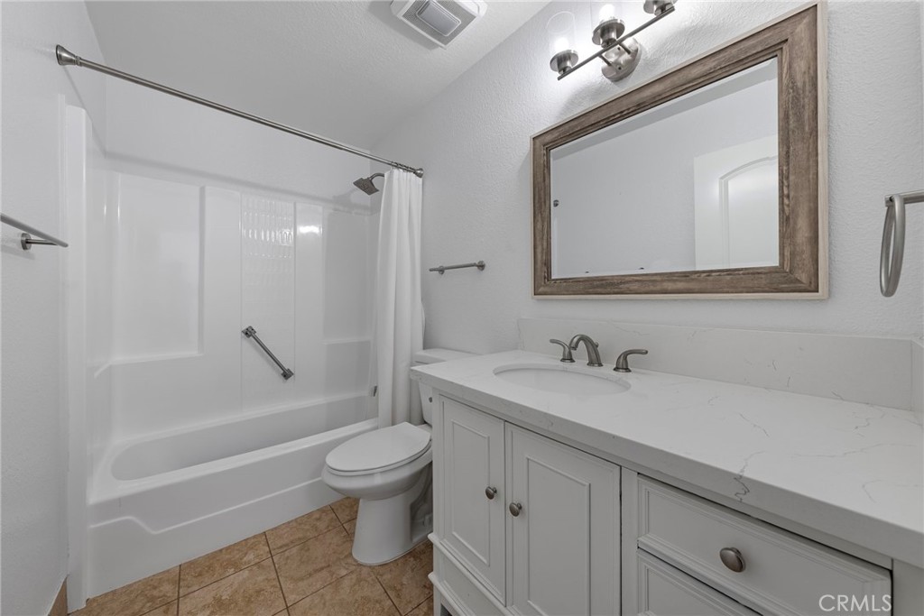 22287 Modina Laguna Hills, CA 92653 - Photo 19 of 25 a bathroom with a toilet a sink a mirror a bathtub and vanity