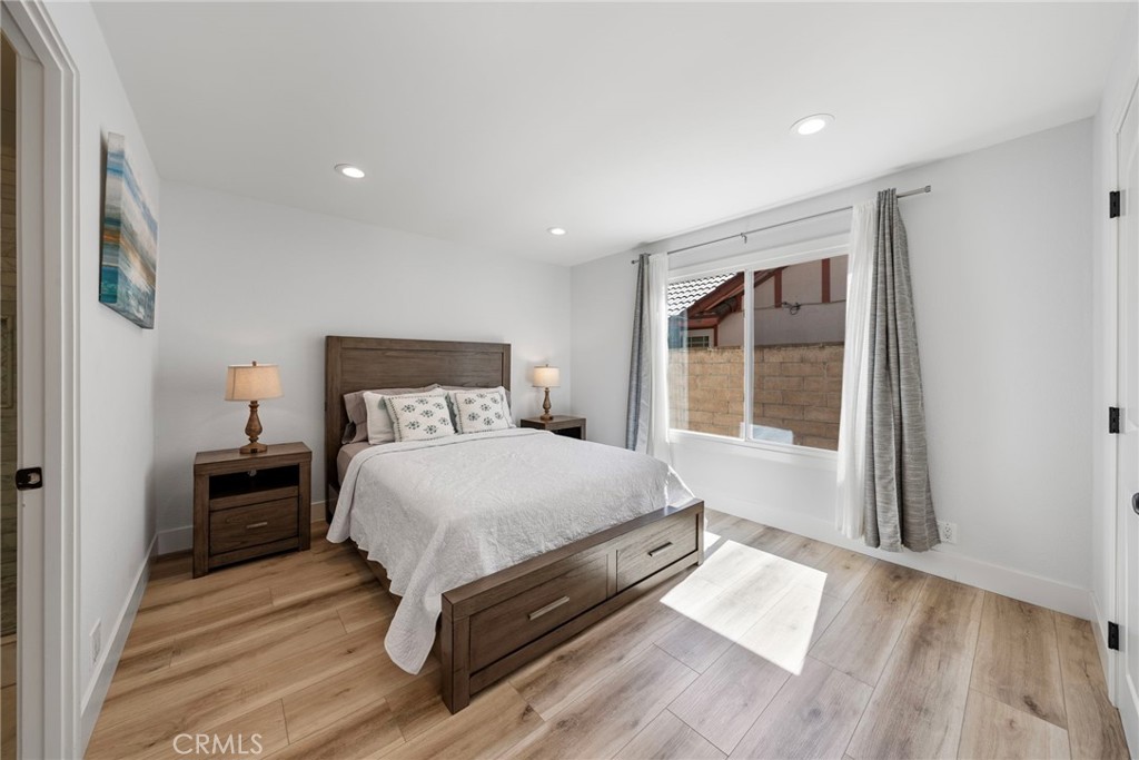 22287 Modina Laguna Hills, CA 92653 - Photo 20 of 25 a bedroom with a bed and wooden floor