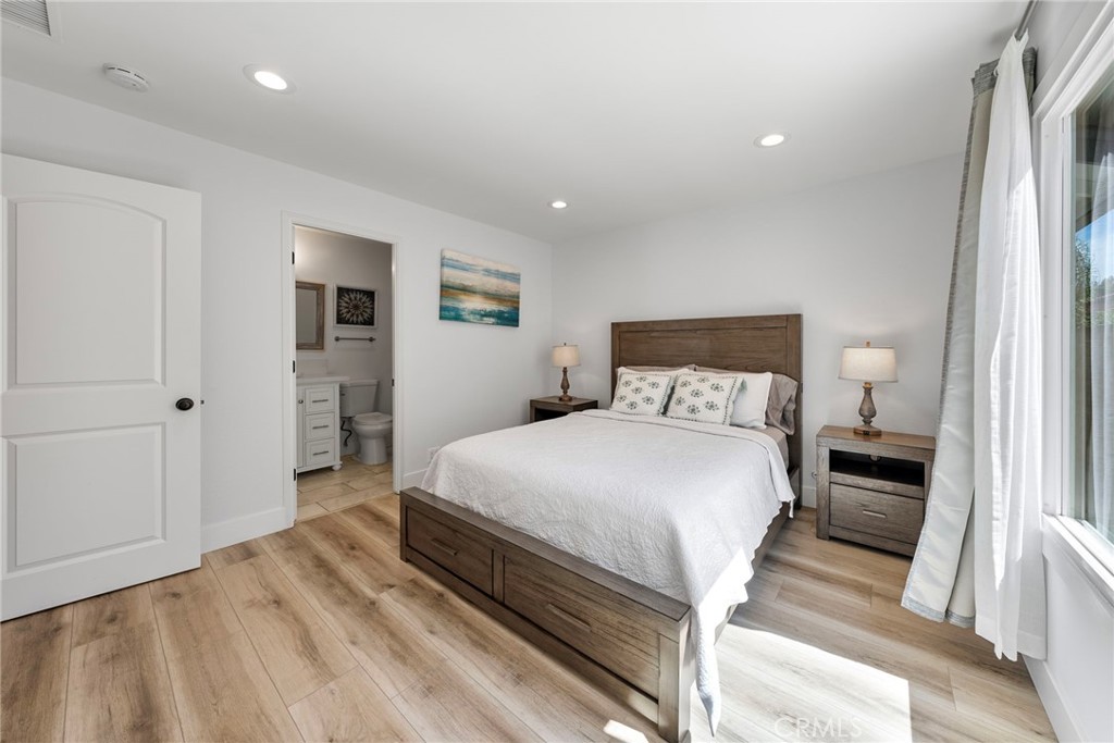 22287 Modina Laguna Hills, CA 92653 - Photo 21 of 25 a bedroom with a bed and a large mirror