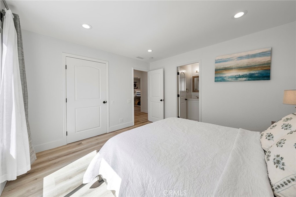 22287 Modina Laguna Hills, CA 92653 - Photo 22 of 25 a bedroom with a bed and painting on the wall