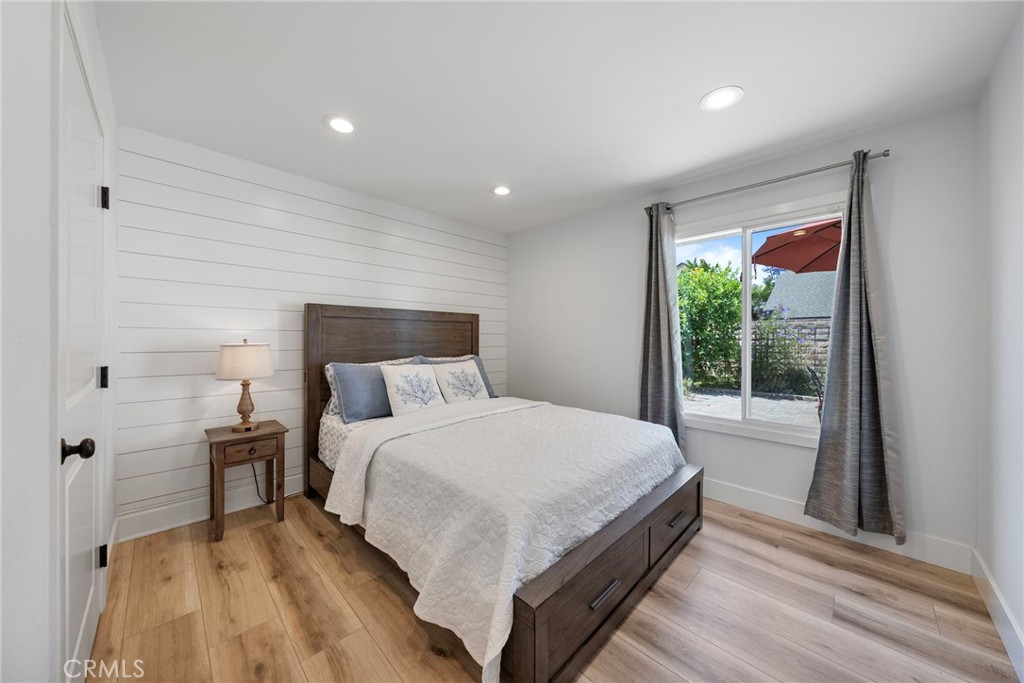 22287 Modina Laguna Hills, CA 92653 - Photo 25 of 25 a large bedroom with a bed and wooden floor