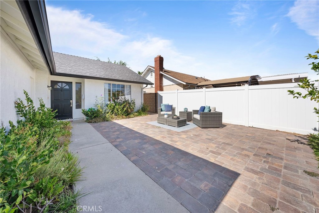 22287 Modina Laguna Hills, CA 92653 - Photo 4 of 25 a view of a house with a floor to ceiling windows and potted plants