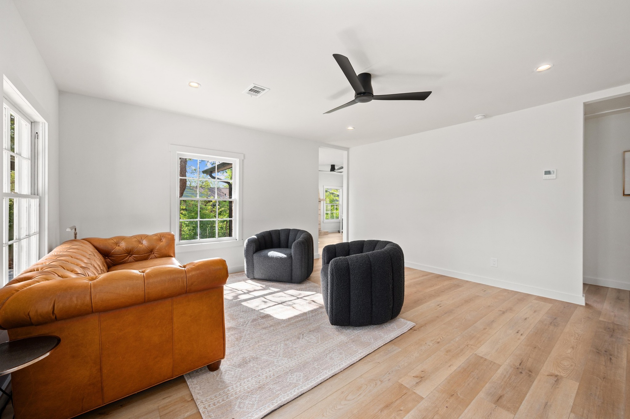3501 Pecan Springs Road Austin, TX 78723 - Photo 9 of 40 Living room with recessed lighting, light wood finished floors, and ceiling​​‌​​​​‌​​‌‌​‌‌​​‌​​​​‌​​​‌‌​‌‌‌ fan