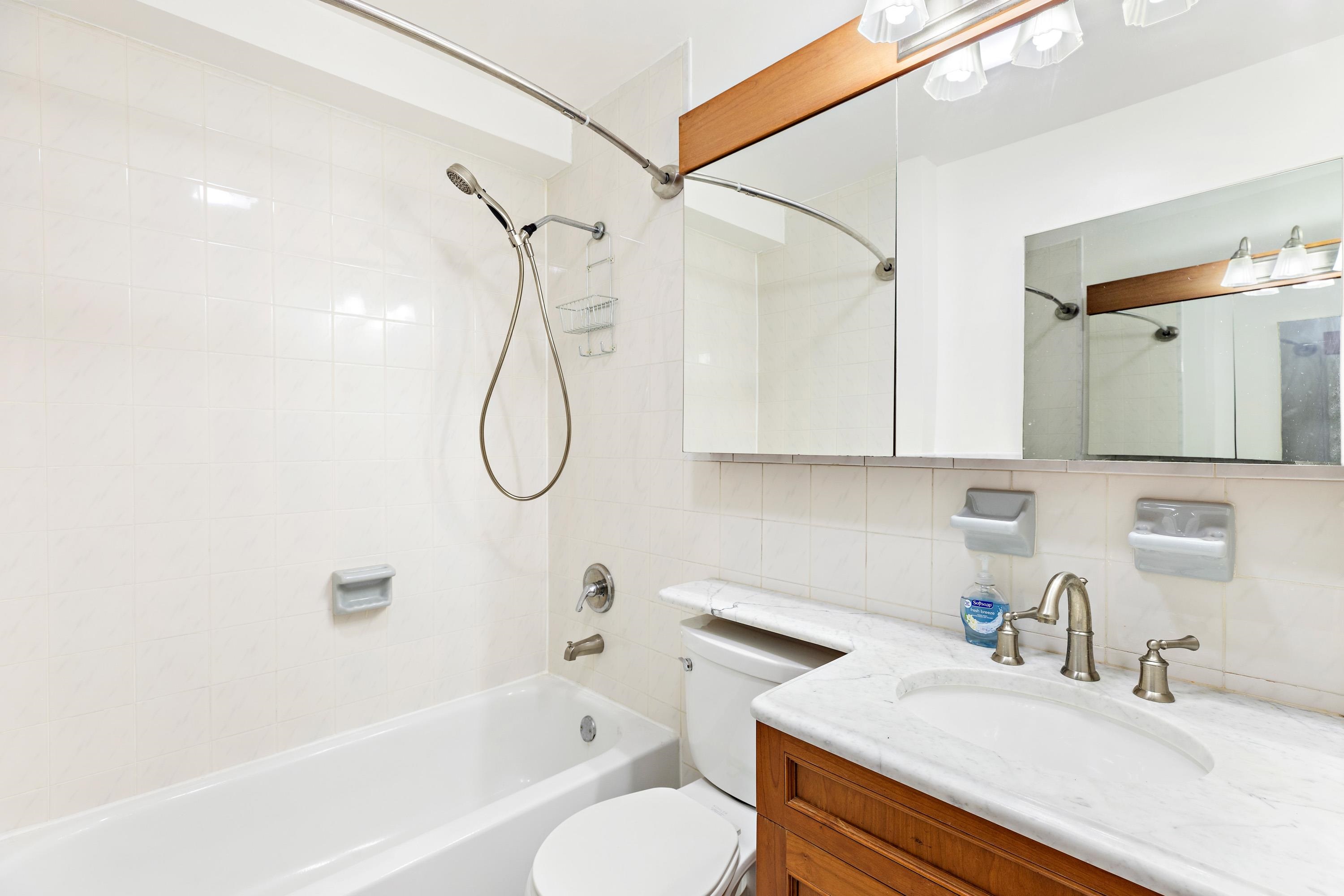 56 Ferguson Street, Unit C2 Newark, NJ 07105 - Photo 12 of 16 a bathroom with a granite countertop sink a toilet and a bathtub