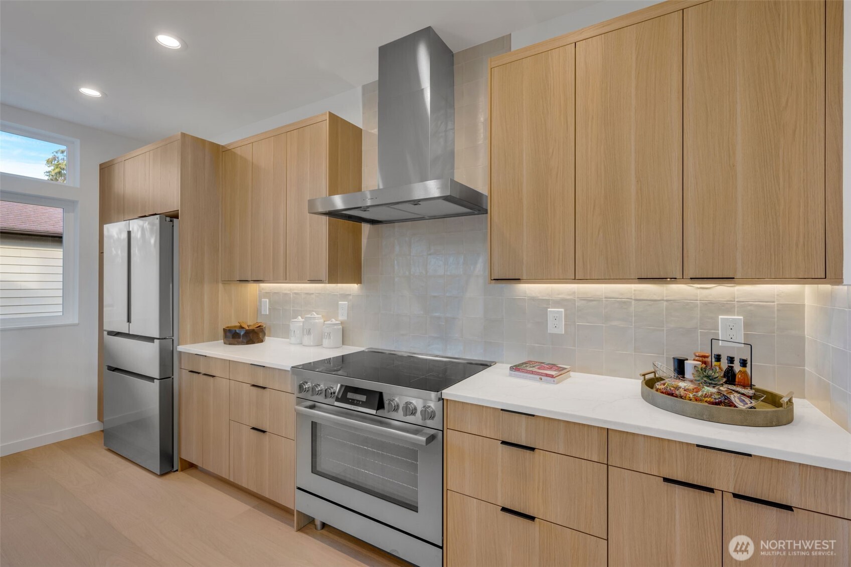 5642 49th Avenue Southwest Seattle, WA 98136 - Photo 11 of 39 a kitchen with stainless steel appliances a sink cabinets and a refrigerator