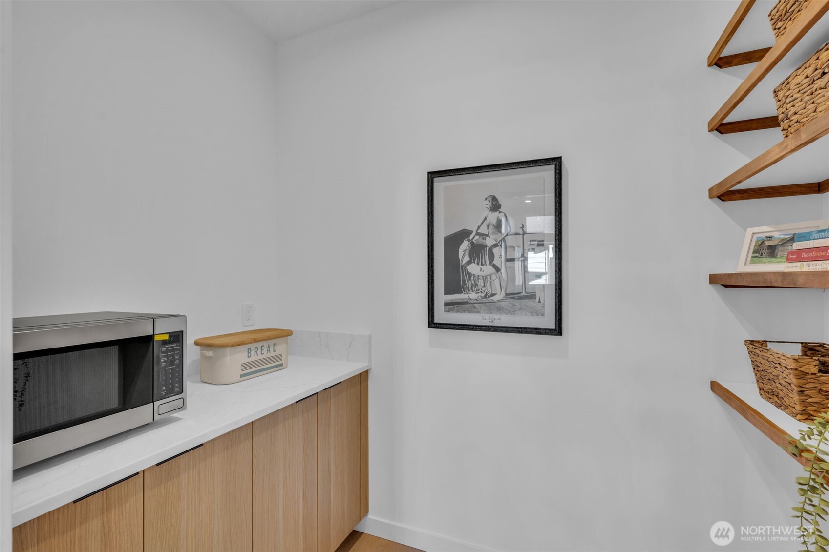 5642 49th Avenue Southwest Seattle, WA 98136 - Photo 14 of 39 a hallway with a microwave and dresser