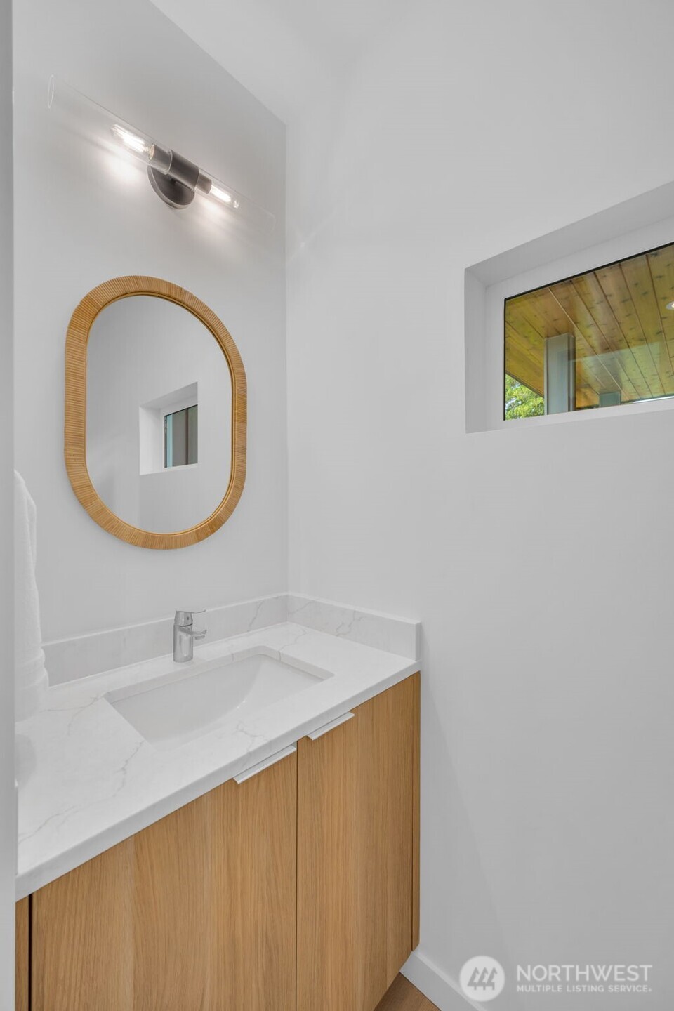 5642 49th Avenue Southwest Seattle, WA 98136 - Photo 23 of 39 a bathroom with a sink and a mirror