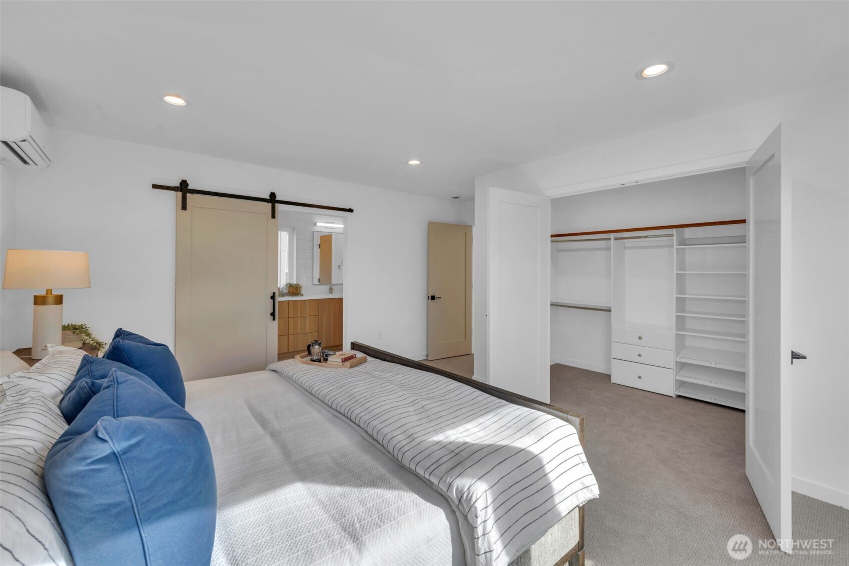 5642 49th Avenue Southwest Seattle, WA 98136 - Photo 28 of 39 a bed room with a bed and cabinets