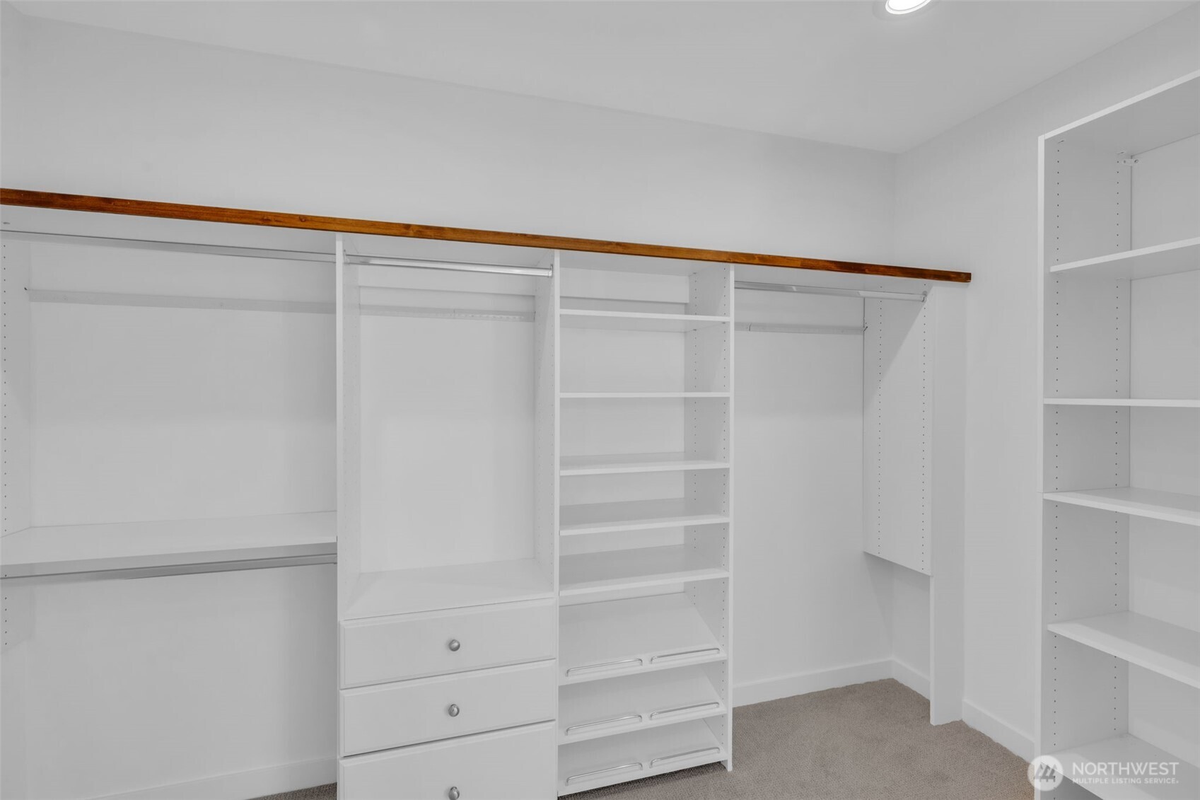 5642 49th Avenue Southwest Seattle, WA 98136 - Photo 29 of 39 a view of walk in closet with empty racks