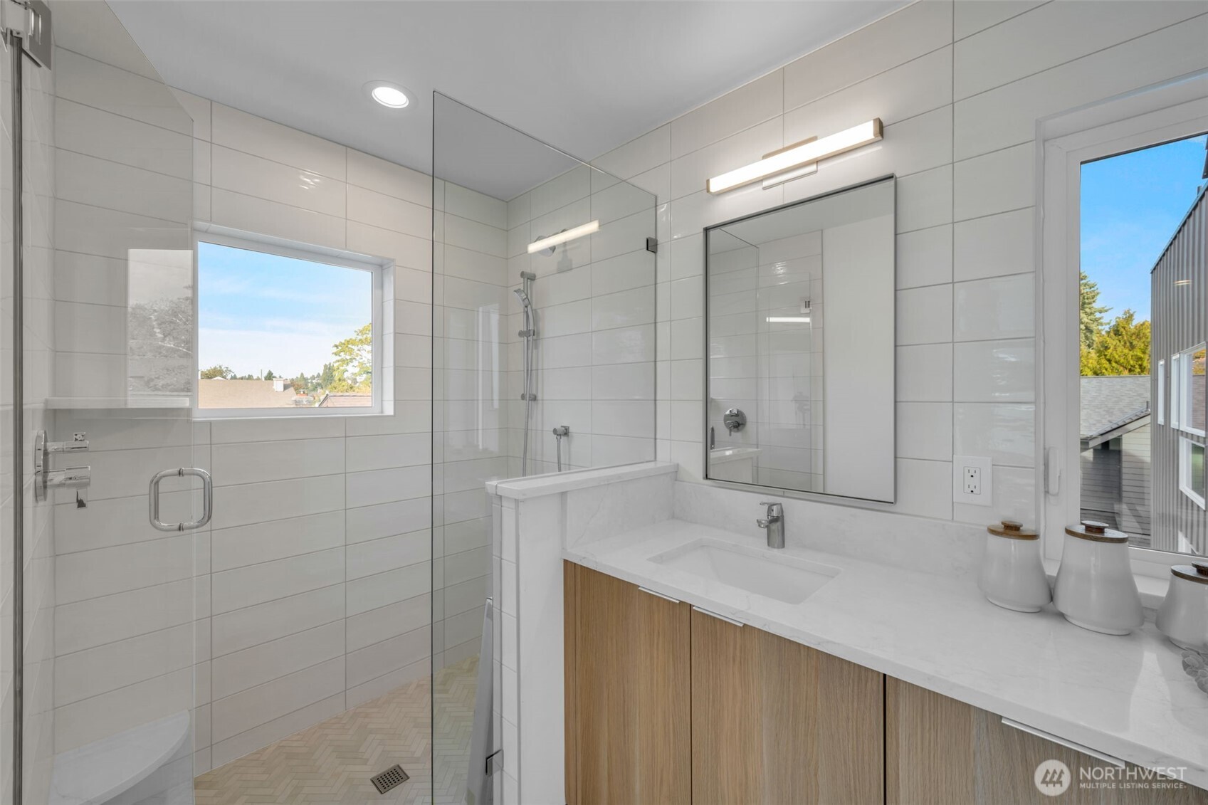 5642 49th Avenue Southwest Seattle, WA 98136 - Photo 31 of 39 a bathroom with a double vanity sink mirror and shower