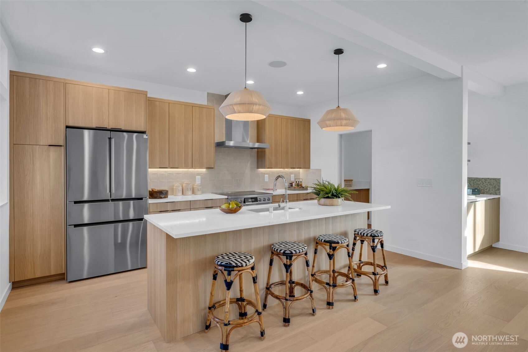 5642 49th Avenue Southwest Seattle, WA 98136 - Photo 10 of 39 a kitchen with stainless steel appliances granite countertop a sink a stove a refrigerator and island with wooden floor