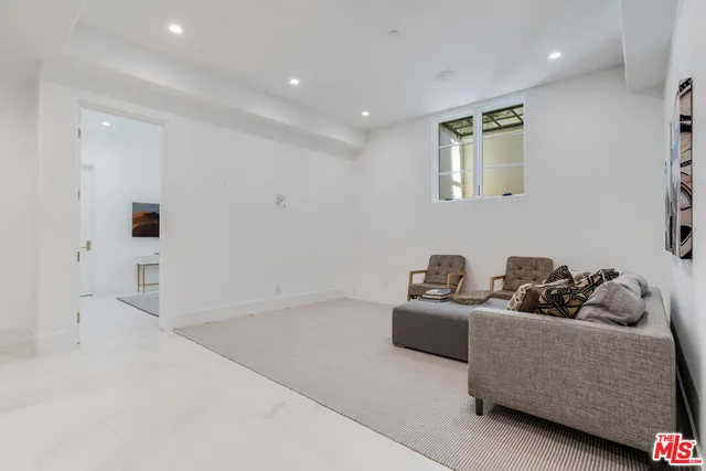 a living room with furniture and white walls