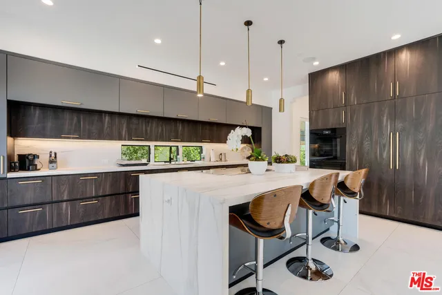a kitchen with stainless steel appliances kitchen island a large island in the center