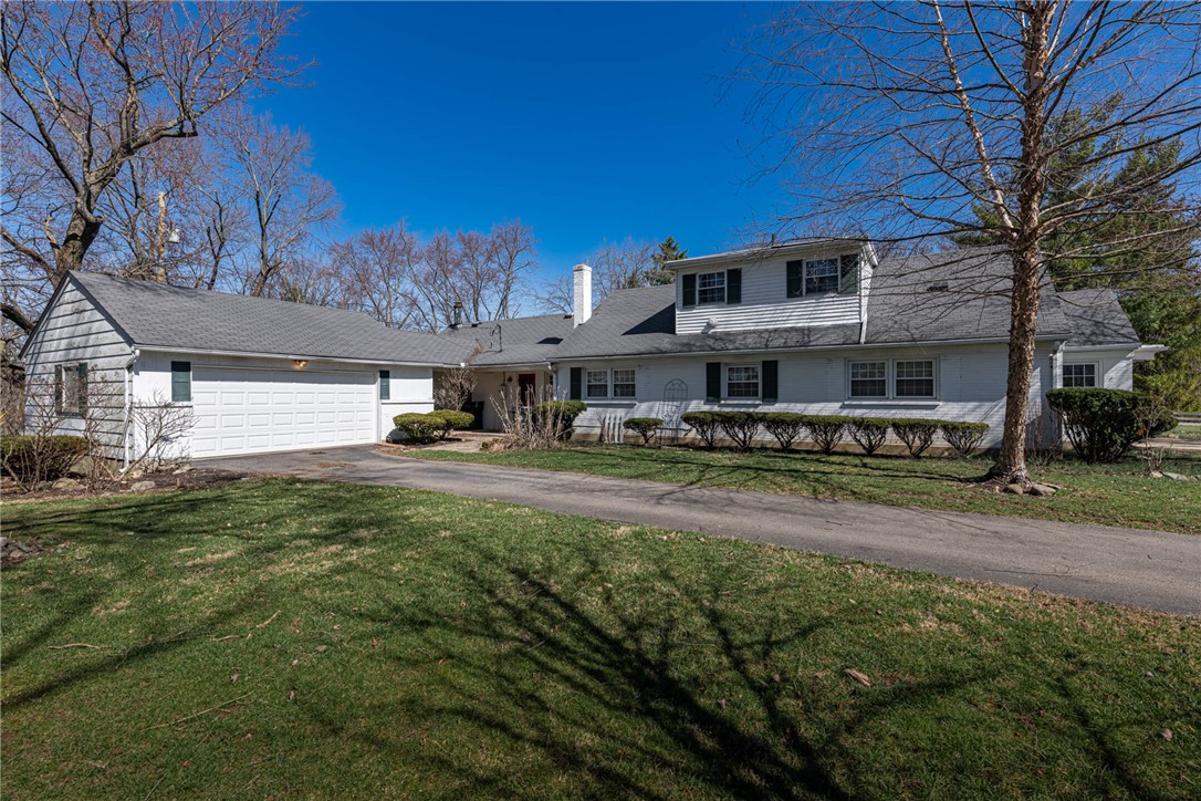 6885 Garber Road Clayton, OH 45415 - Photo 22 of 24 This classic white home features a spacious driveway and attached garage.