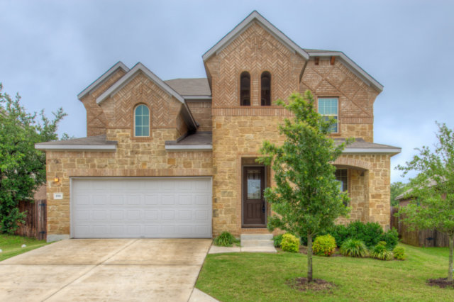 198 Stone View Trail Austin, TX 78737 - Photo 1 of 10 a front view of a house with a yard and garage
