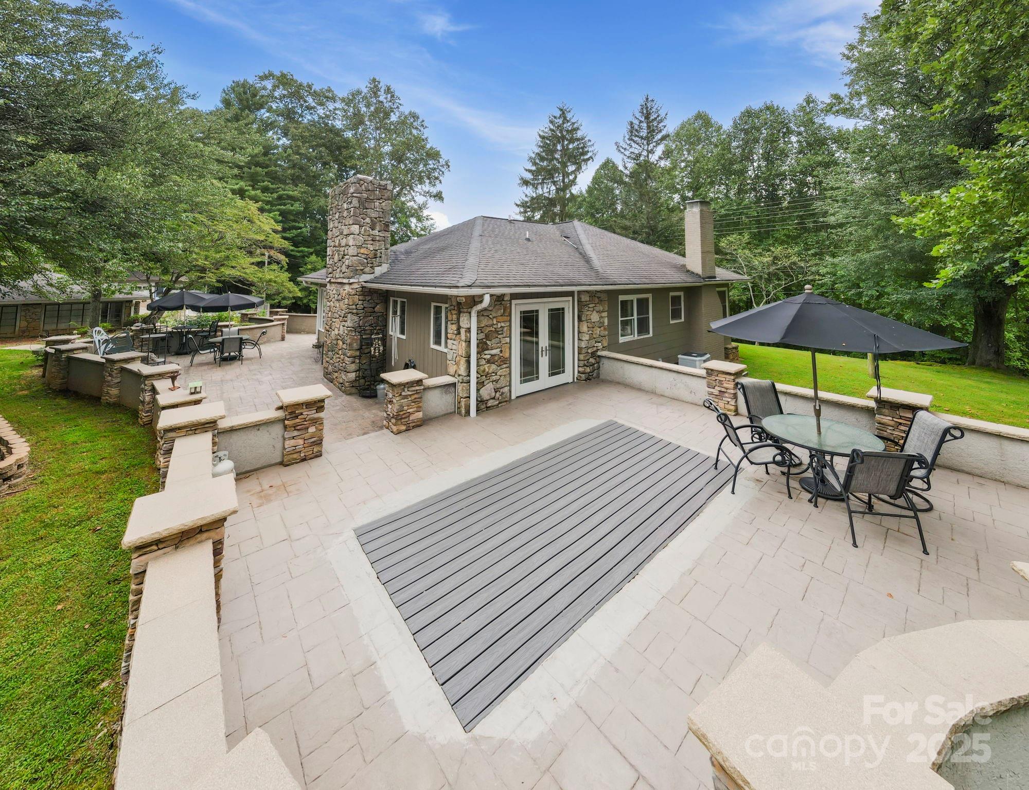 7741 Brevard Road Etowah, NC 28729 - Photo 11 of 48 an outdoor space with furniture and umbrella