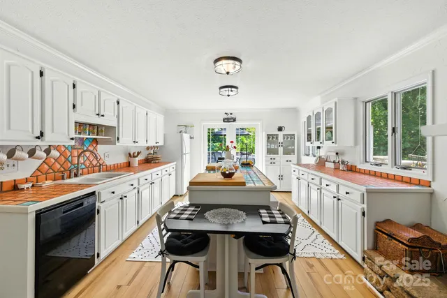 a kitchen with kitchen island granite countertop lots of counter top space and stainless steel appliances