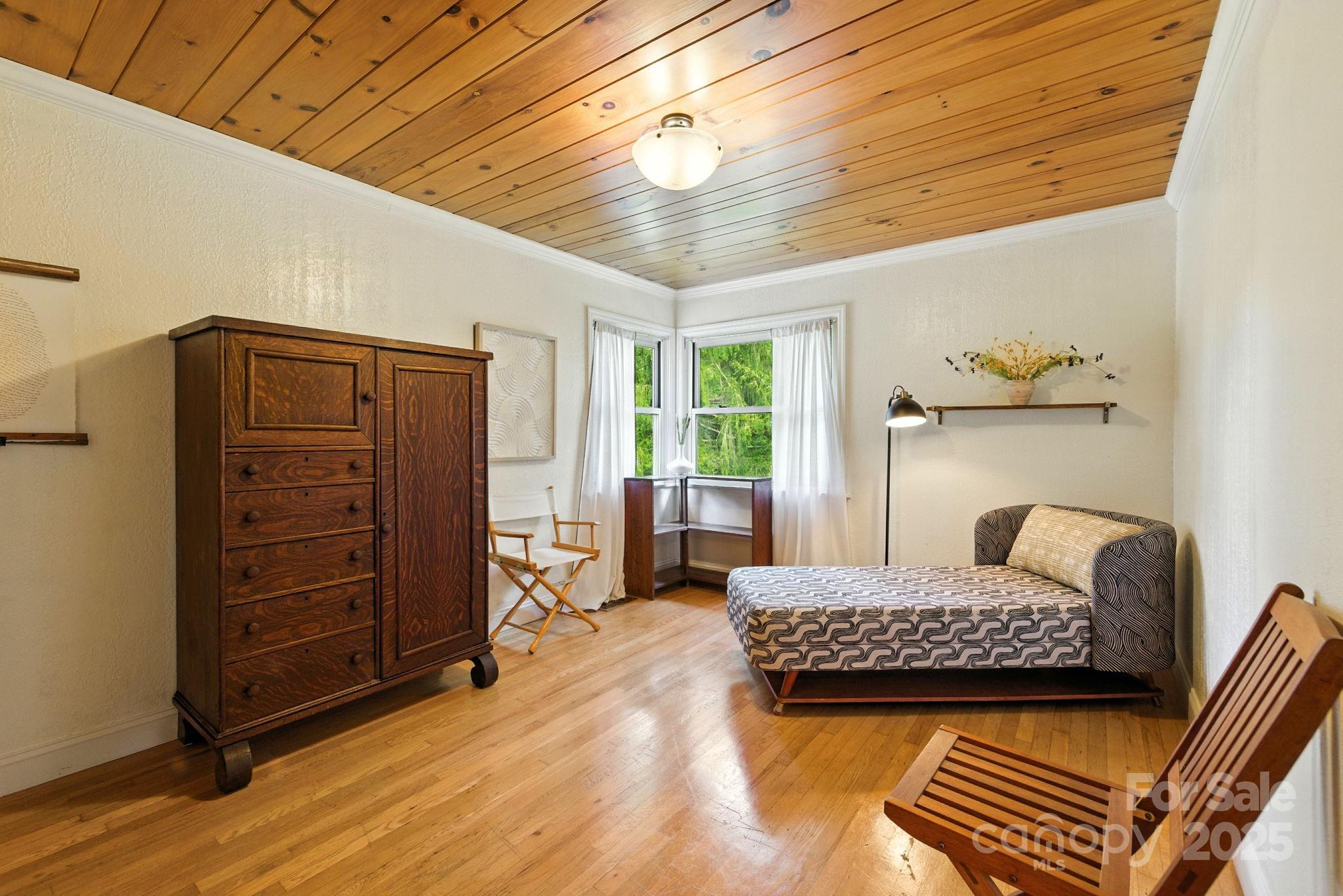 7741 Brevard Road Etowah, NC 28729 - Photo 21 of 48 a bedroom with a bed and furniture