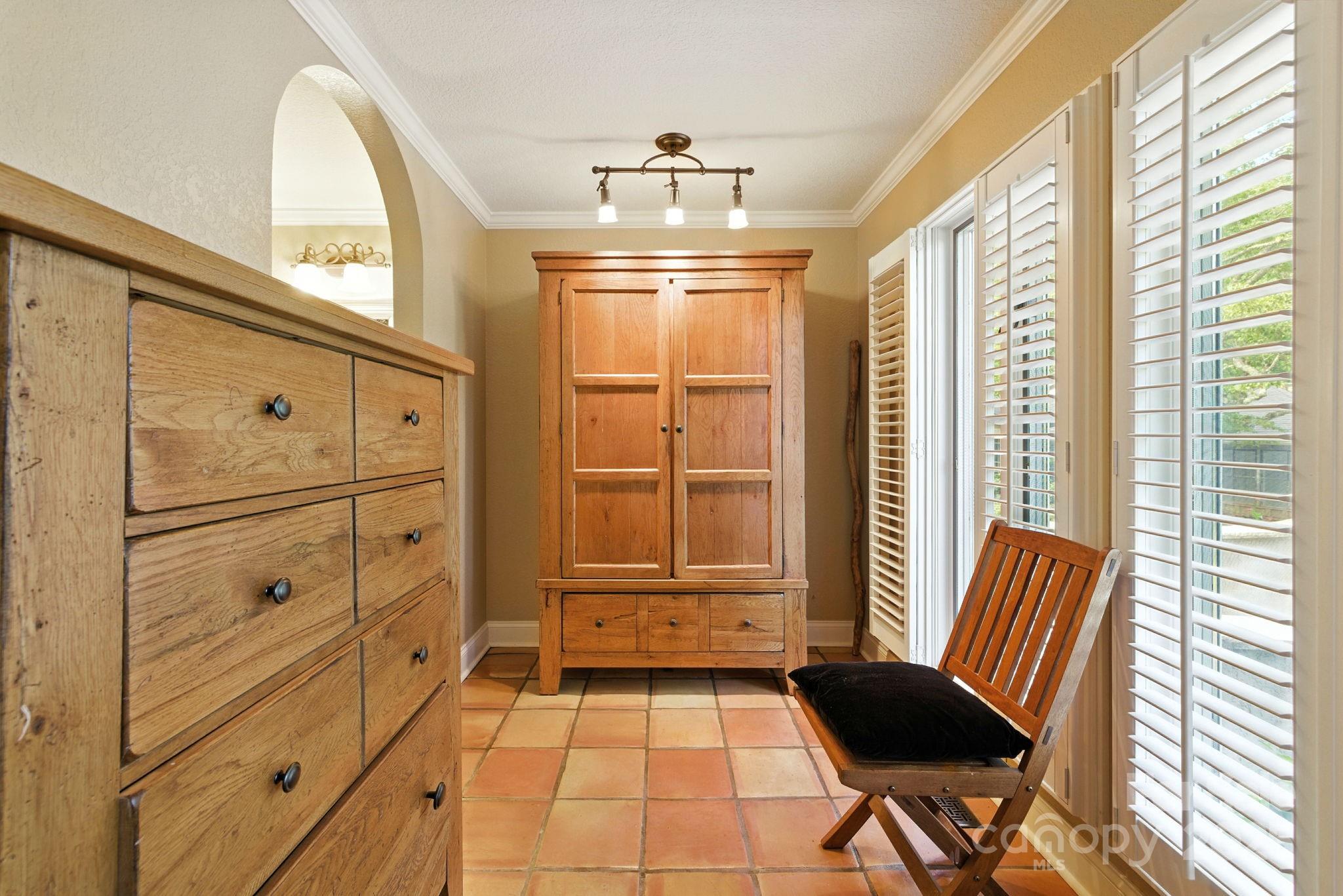 7741 Brevard Road Etowah, NC 28729 - Photo 22 of 48 a view of a hallway with windows and chandelier