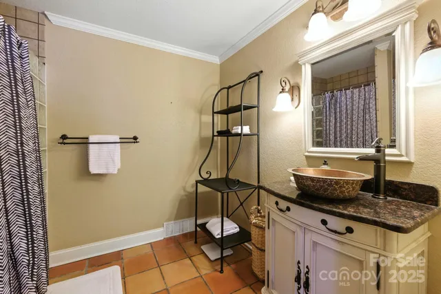 a bathroom with a double vanity sink mirror and shower