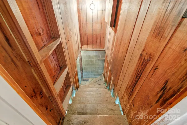 a view of a room with wooden walls