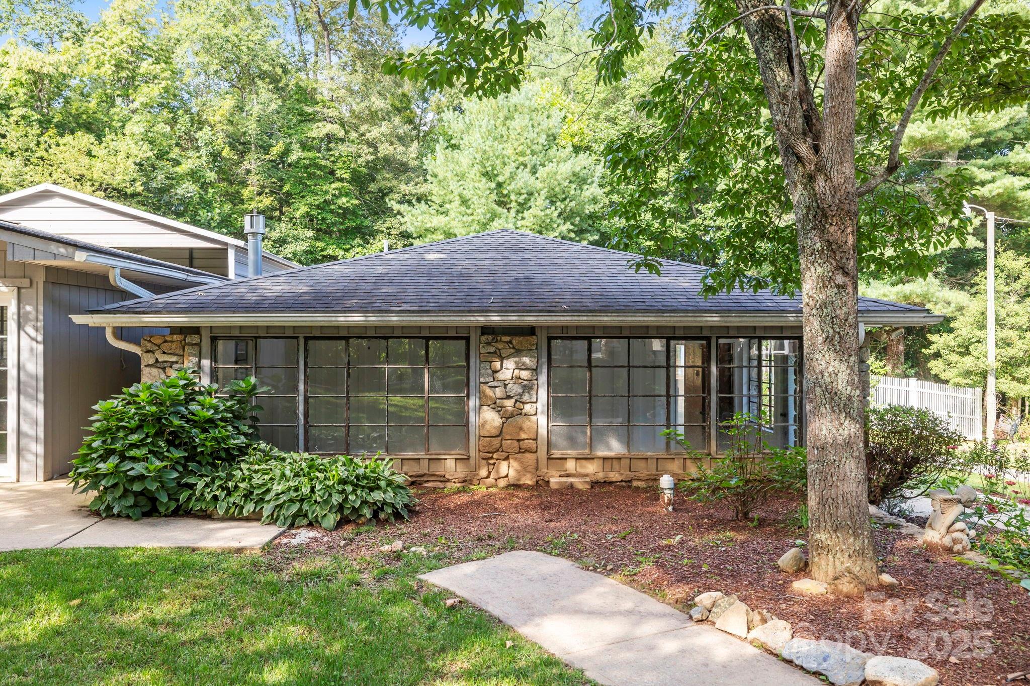 7741 Brevard Road Etowah, NC 28729 - Photo 32 of 48 a front view of a house with garden