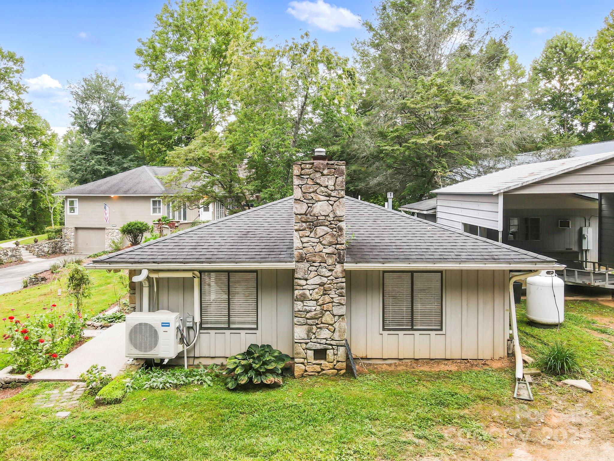 7741 Brevard Road Etowah, NC 28729 - Photo 33 of 48 a front view of a house with garden