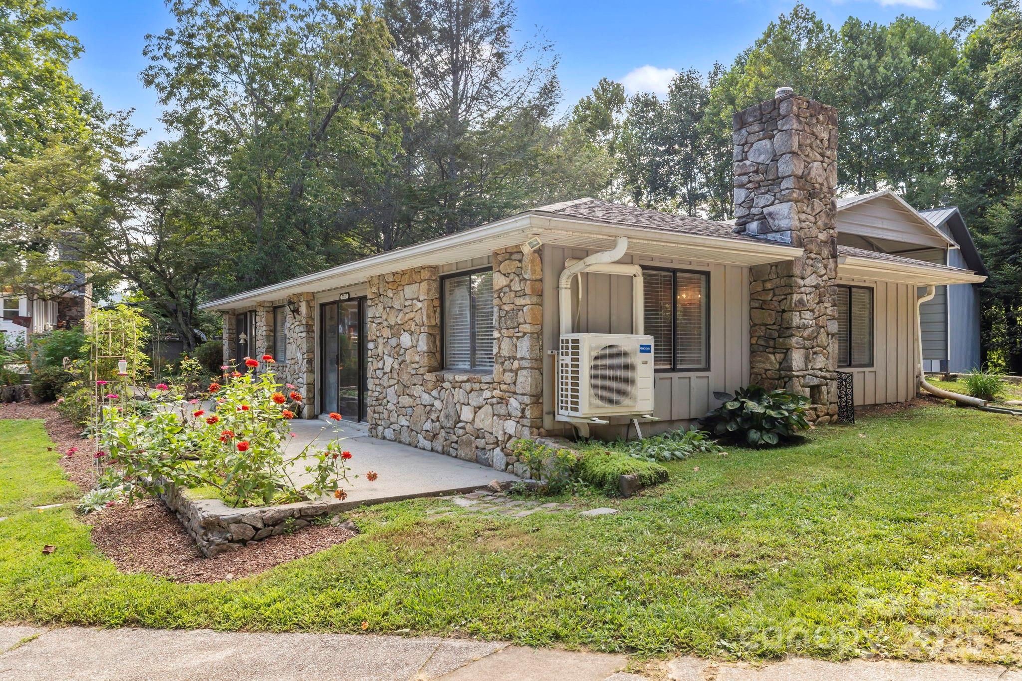 7741 Brevard Road Etowah, NC 28729 - Photo 34 of 48 a front view of a house with garden