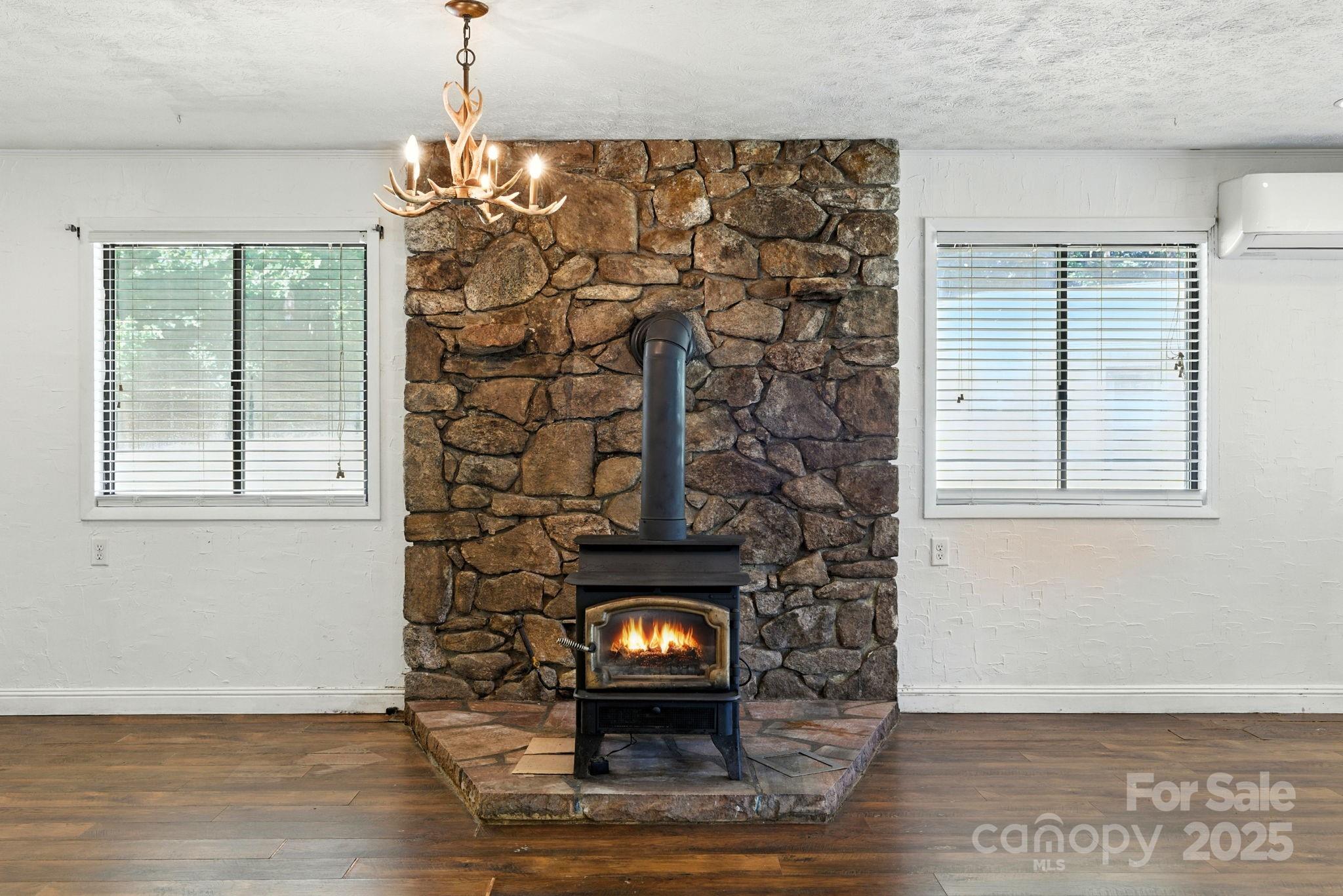 7741 Brevard Road Etowah, NC 28729 - Photo 38 of 48 a room with a fireplace and a window