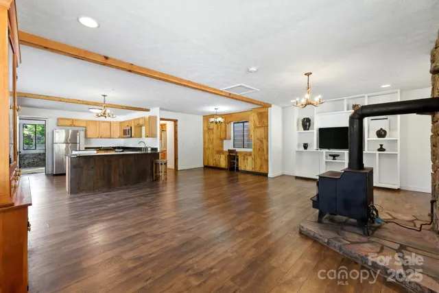 a view of a livingroom with furniture wooden floor and windows
