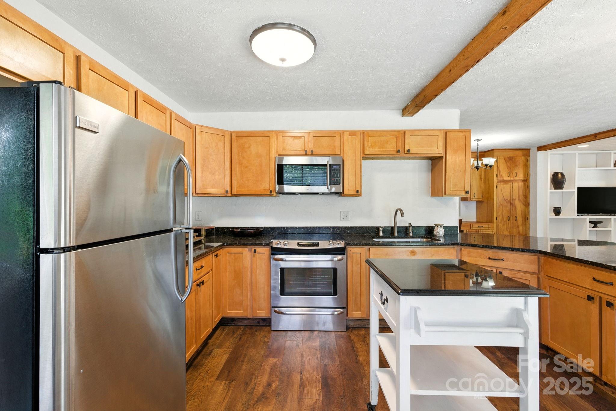 7741 Brevard Road Etowah, NC 28729 - Photo 45 of 48 a kitchen with stainless steel appliances a refrigerator a stove a sink and a microwave