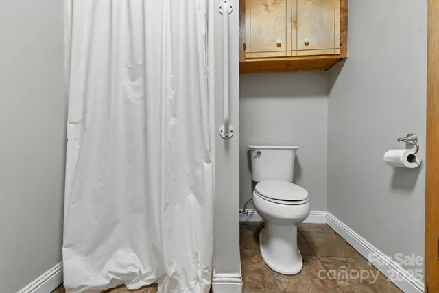a view of a hallway with storage and utility room
