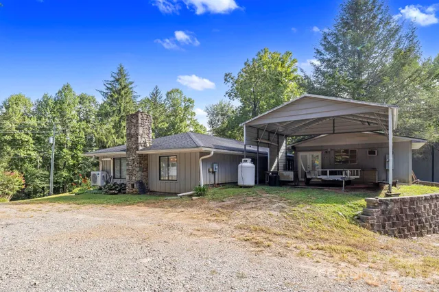 a view of a house with a yard and sitting area