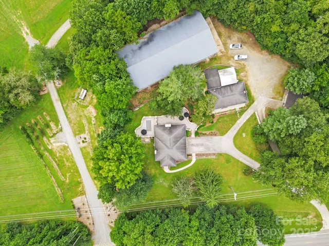 an aerial view of a house with a yard and swimming pool