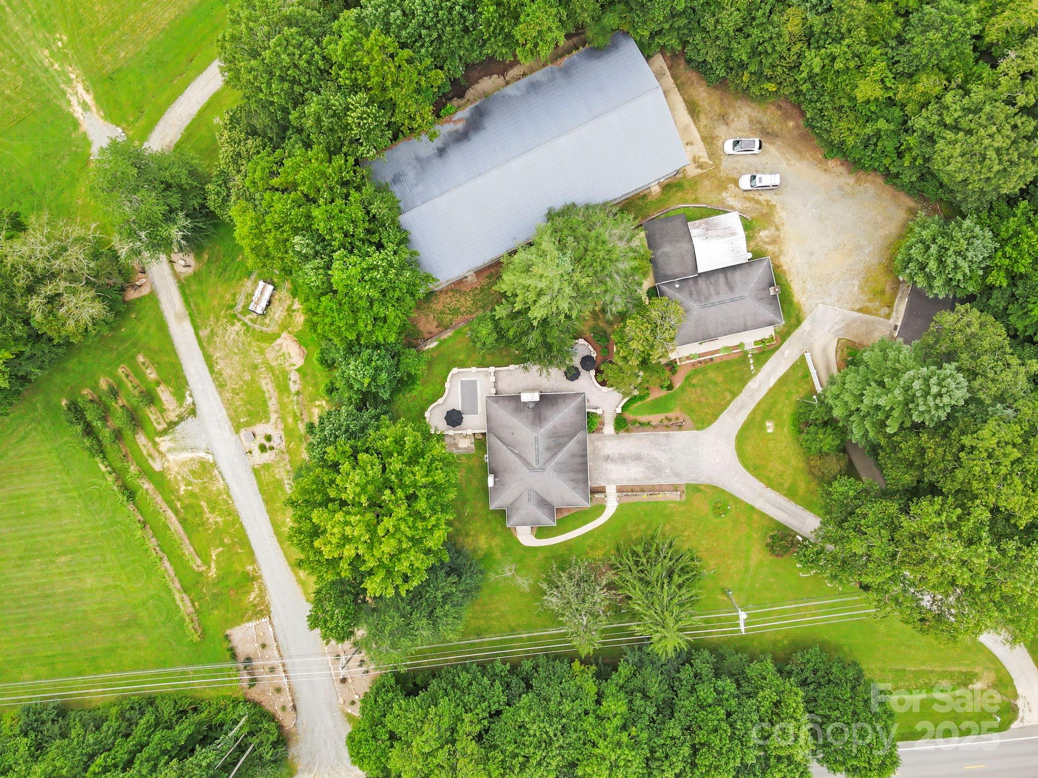 7741 Brevard Road Etowah, NC 28729 - Photo 9 of 48 an aerial view of a house with a yard and swimming pool