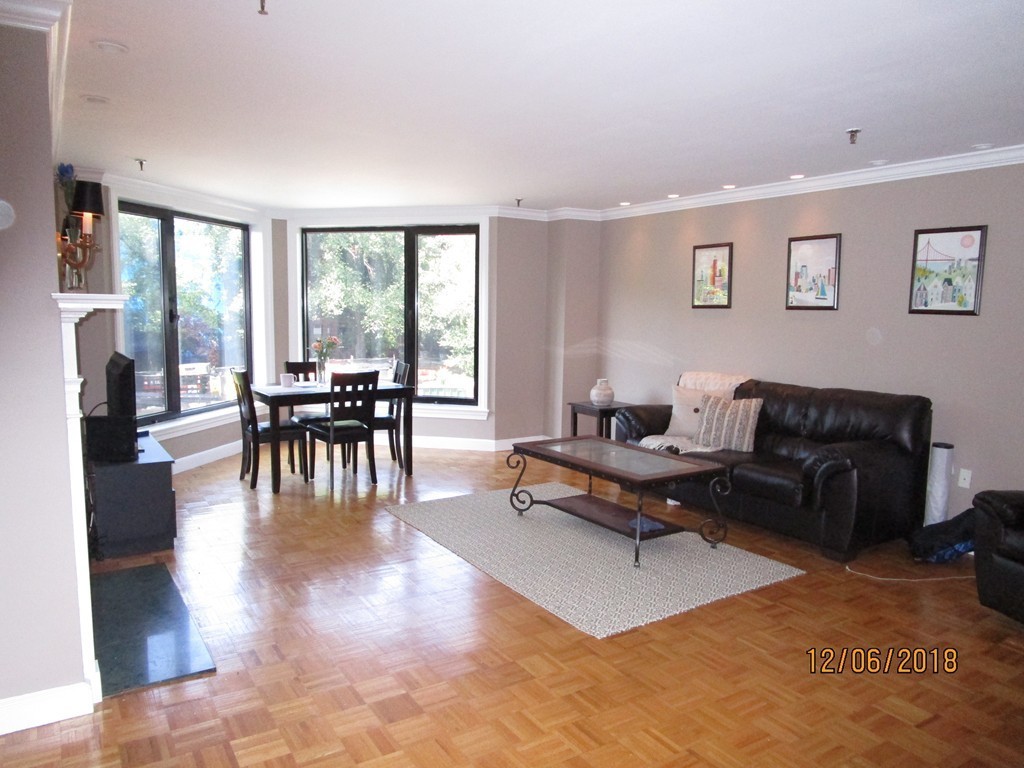 390 Commonwealth Avenue, Unit 210 Boston, MA 02215 - Photo 9 of 30 a living room with furniture two window and a dining table