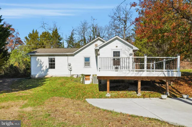 a front view of a house with a yard table and chairs