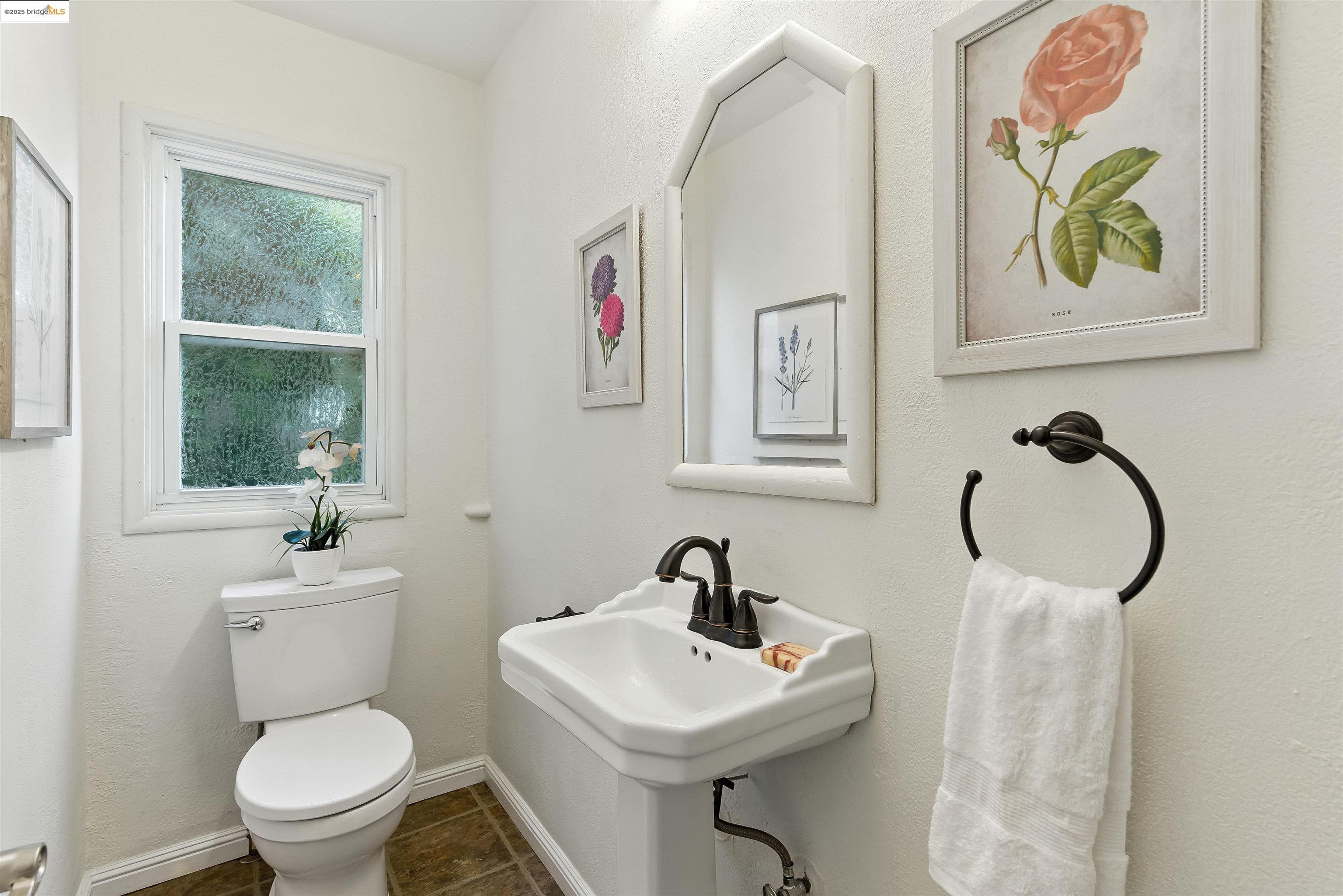 6623 Outlook Avenue Oakland, CA 94605 - Photo 16 of 38 Half bathroom featuring dark tile patterned floors and a textured wall