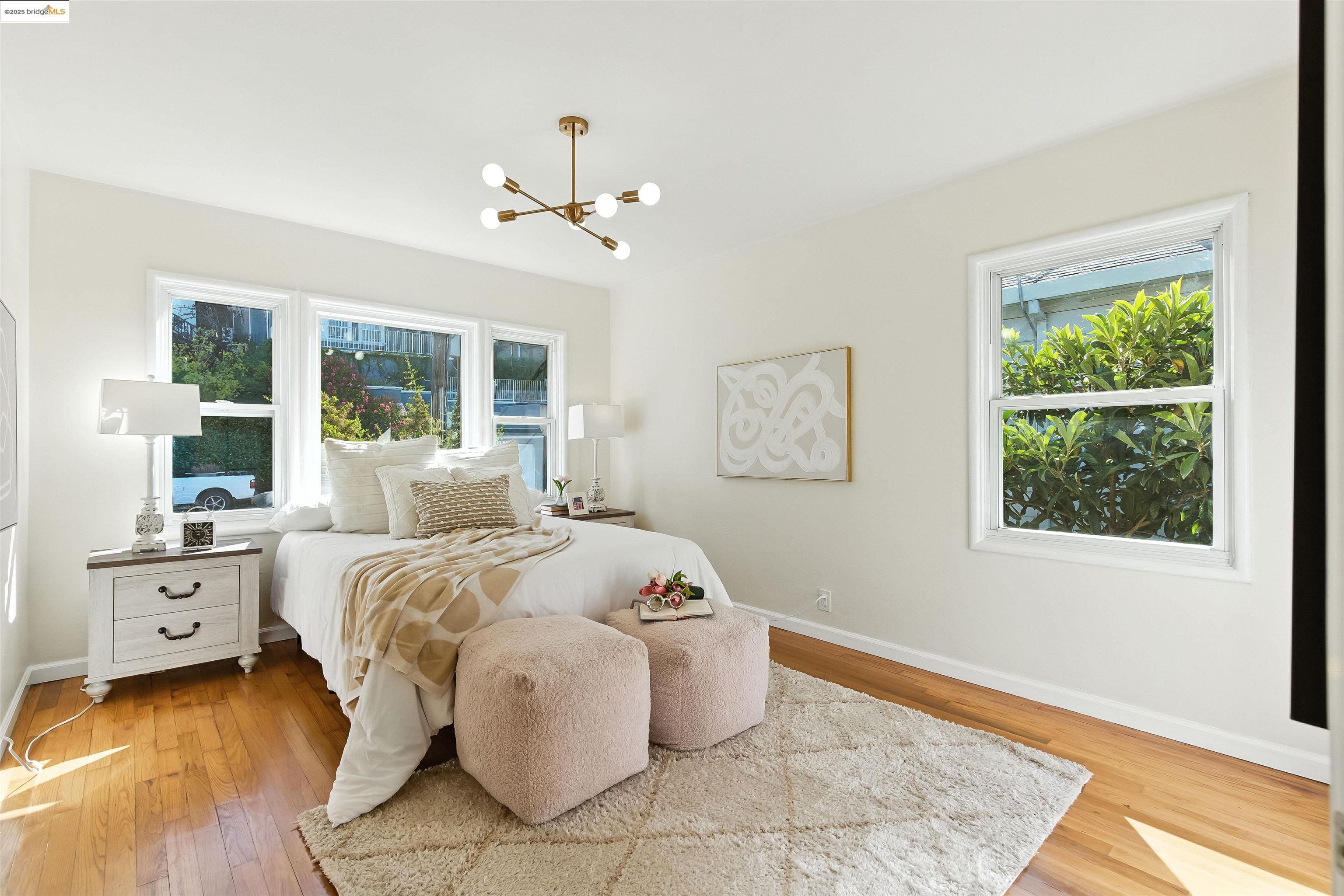 6623 Outlook Avenue Oakland, CA 94605 - Photo 17 of 38 Bedroom with light wood-style flooring and a chandelier