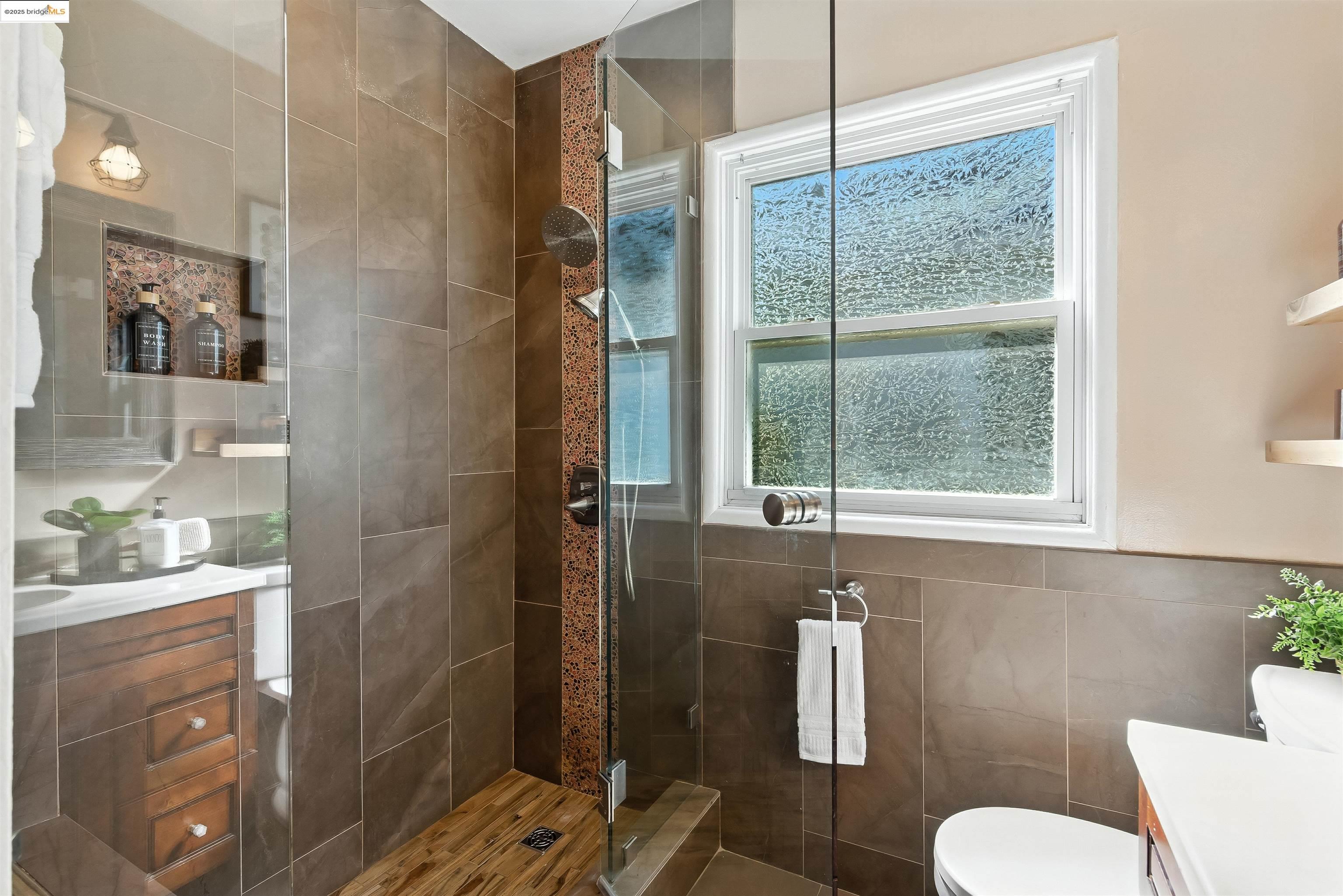 6623 Outlook Avenue Oakland, CA 94605 - Photo 22 of 38 Full bath with vanity, a shower stall, and tile walls