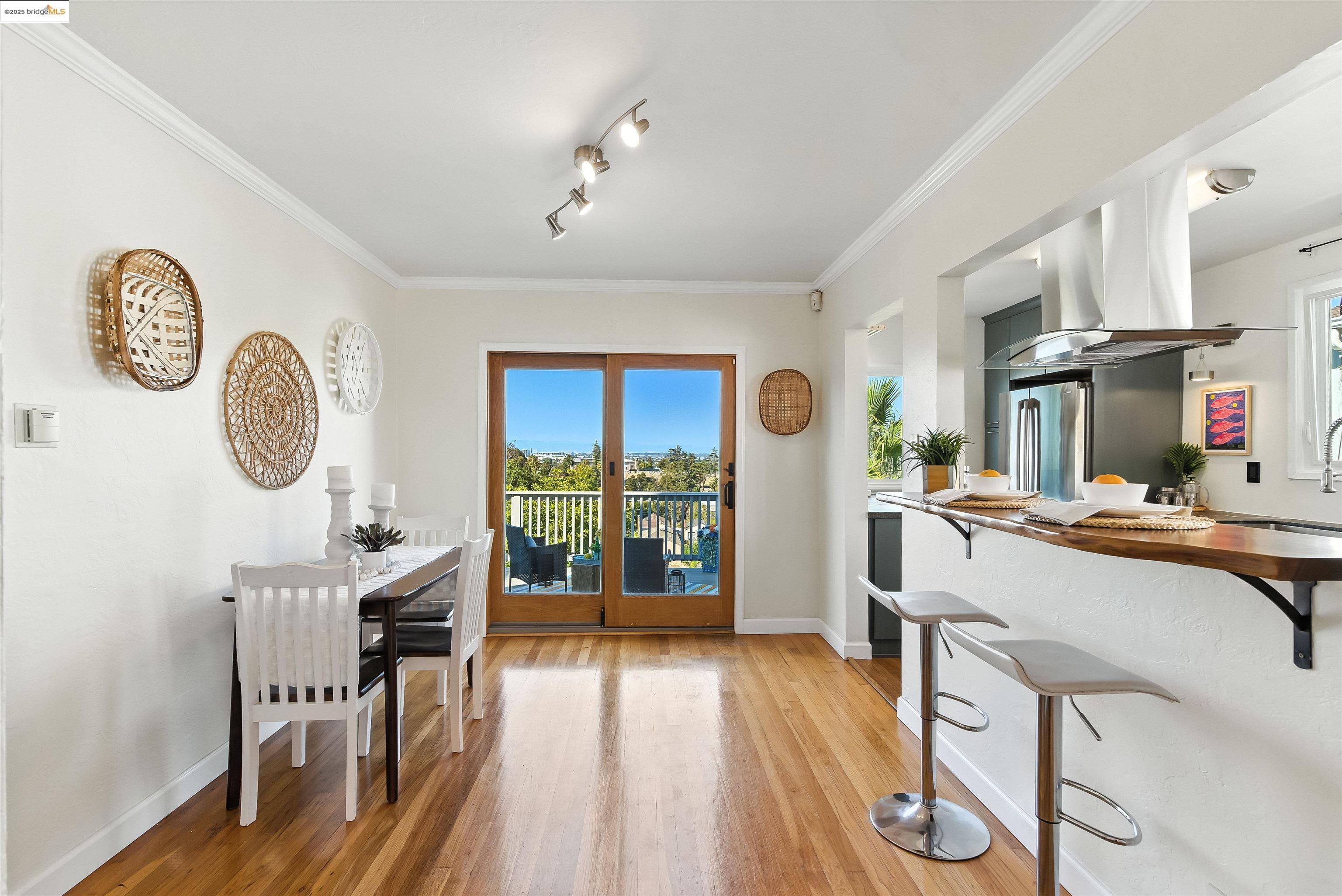 6623 Outlook Avenue Oakland, CA 94605 - Photo 9 of 38 Dining space featuring ornamental molding and light wood finished floors
