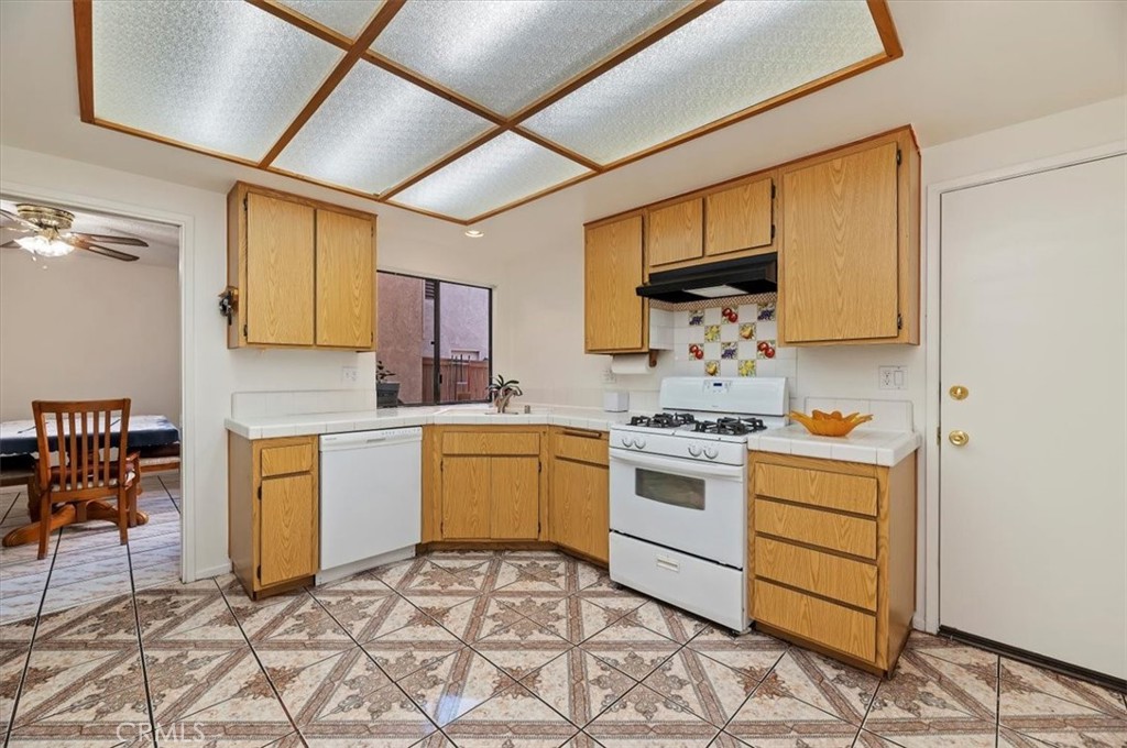 9765 Louise Way Rancho Cucamonga, CA 91730 - Photo 11 of 28 a kitchen with a stove a sink and a refrigerator