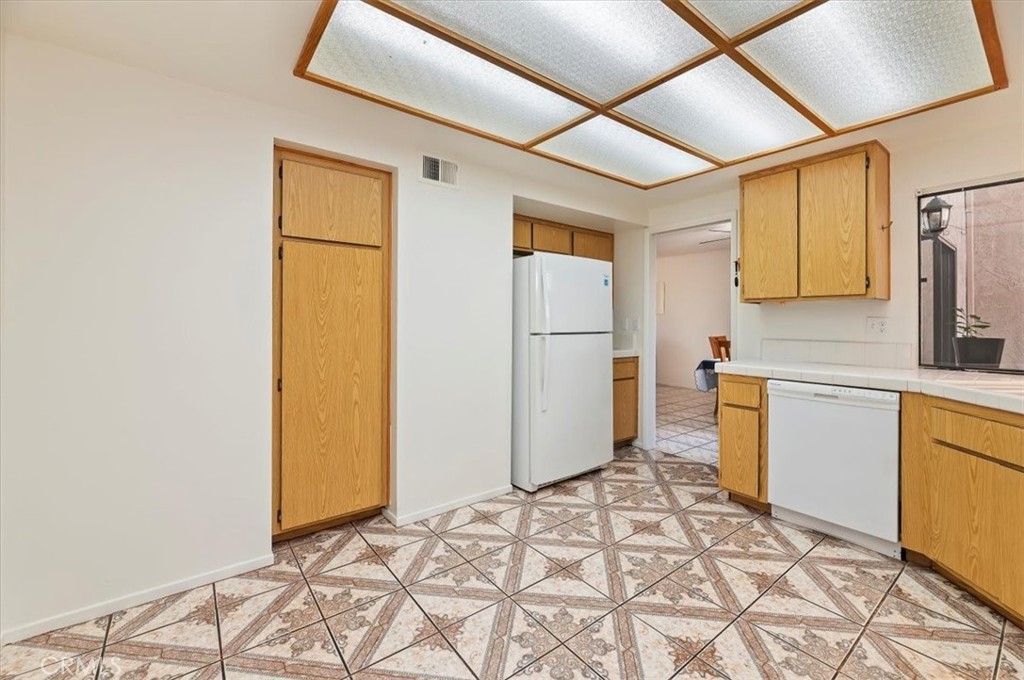 9765 Louise Way Rancho Cucamonga, CA 91730 - Photo 13 of 28 a kitchen with a refrigerator and a stove