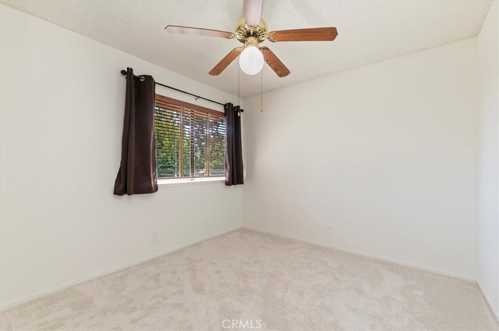 9765 Louise Way Rancho Cucamonga, CA 91730 - Photo 16 of 28 an empty room with windows and fan