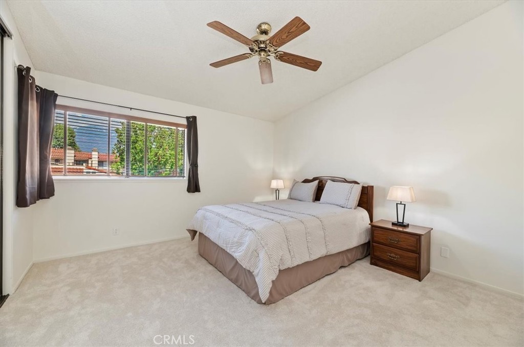 9765 Louise Way Rancho Cucamonga, CA 91730 - Photo 19 of 28 a spacious bedroom with a bed and window