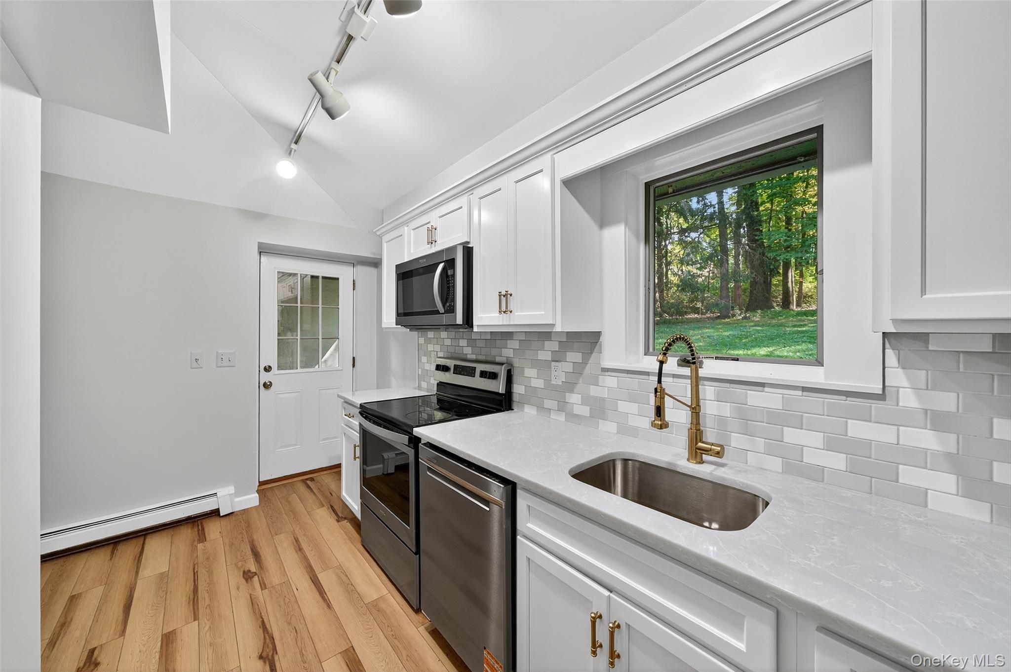 91 Sleepy Valley Road Warwick, NY 10990 - Photo 12 of 30 a kitchen with stainless steel appliances a sink a stove and microwave
