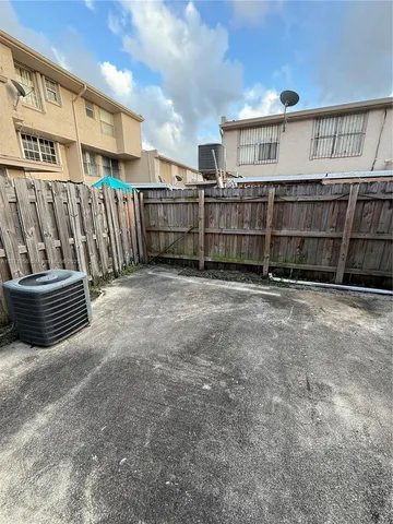 a view of a backyard with wooden fence
