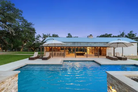 a view of a house with swimming pool and yard