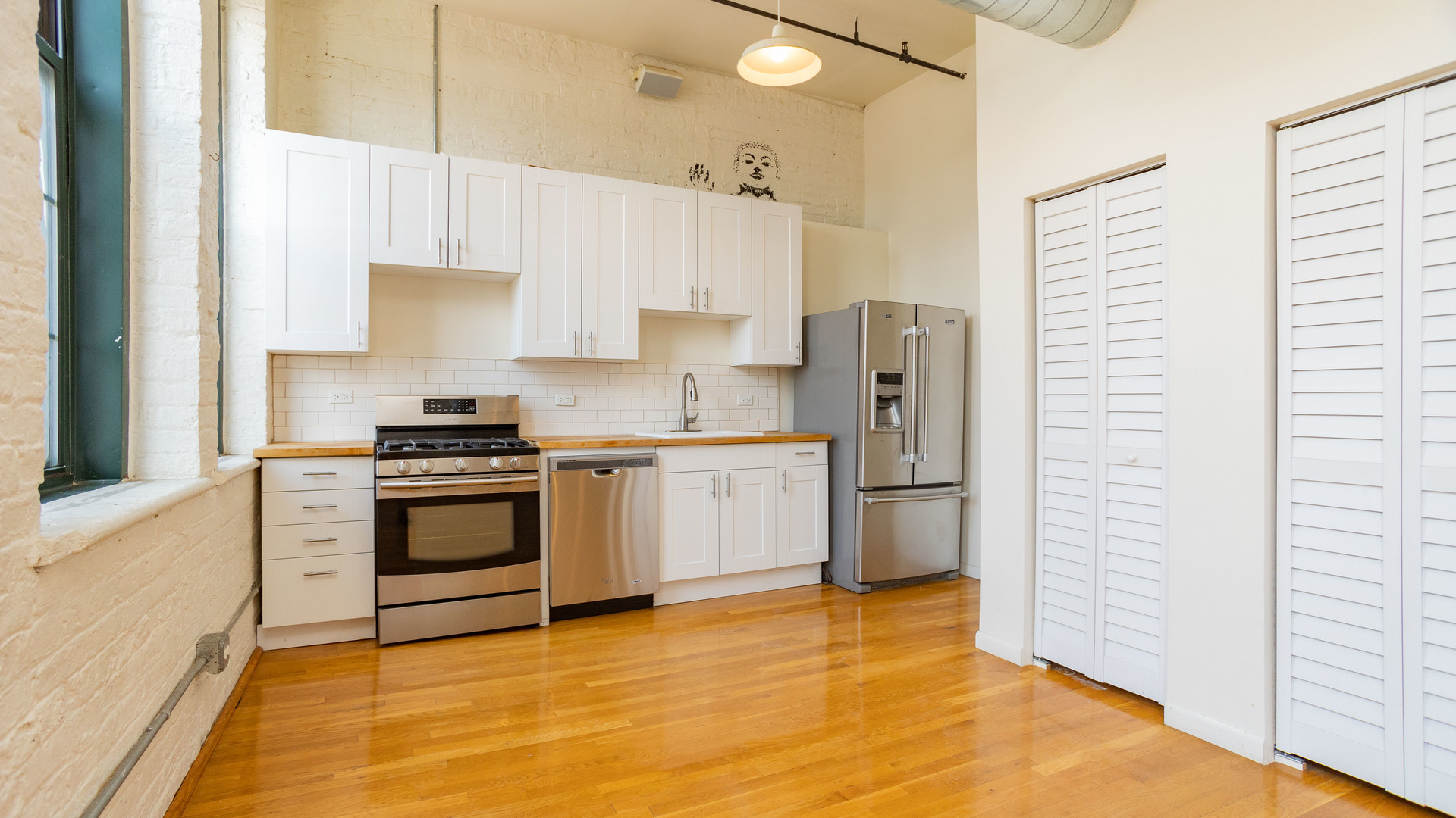 159 North Racine Avenue, Unit 2W Chicago, IL 60607 - Photo 2 of 11 a kitchen with a sink stainless steel appliances and cabinets